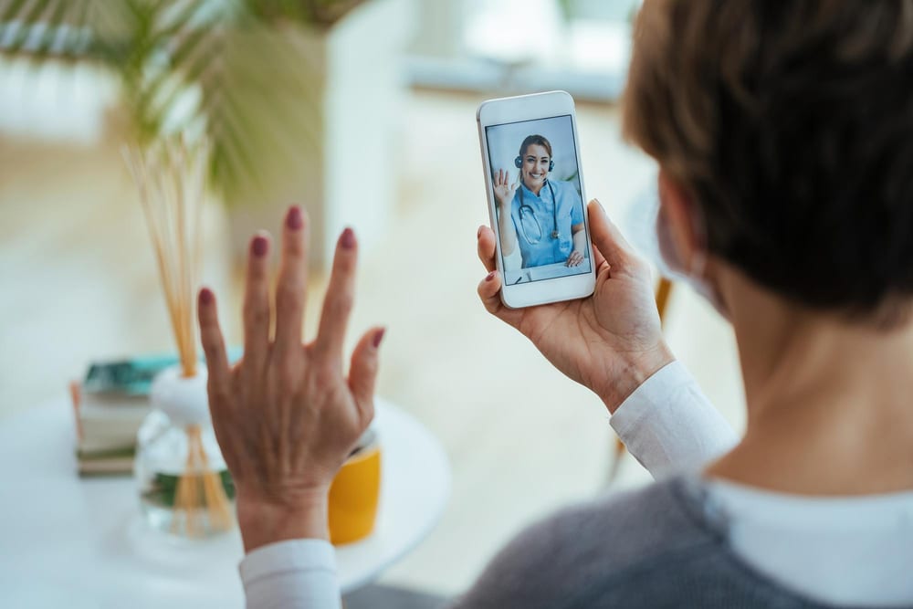 Patient at home speaking with a nurse on a video call